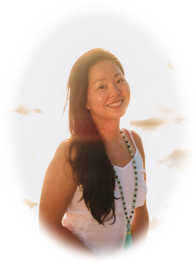 Lucy sitting by the ocean in golden light